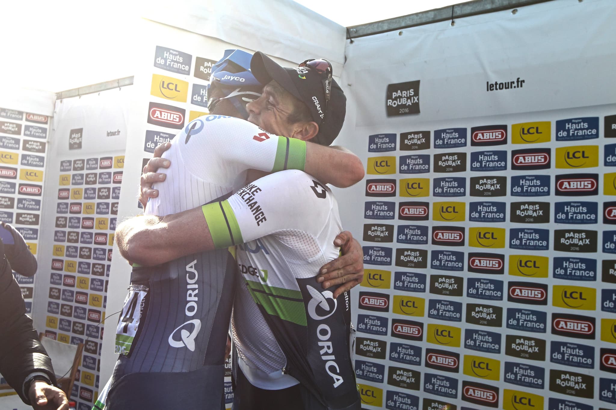 Cyclists hugging at Paris-Roubaix 2016: Jayco AlUla & Orica-BikeExchange