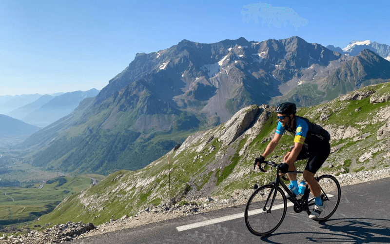 Cyclist on mountain road, scenic landscape