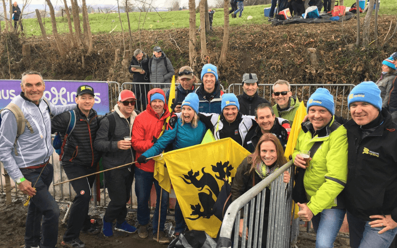 Group of cycling fans with a flag