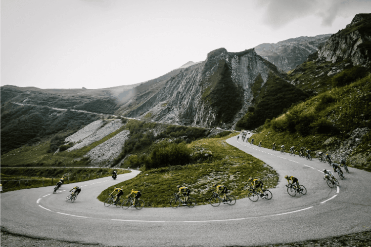 Peloton climbing a winding mountain road
