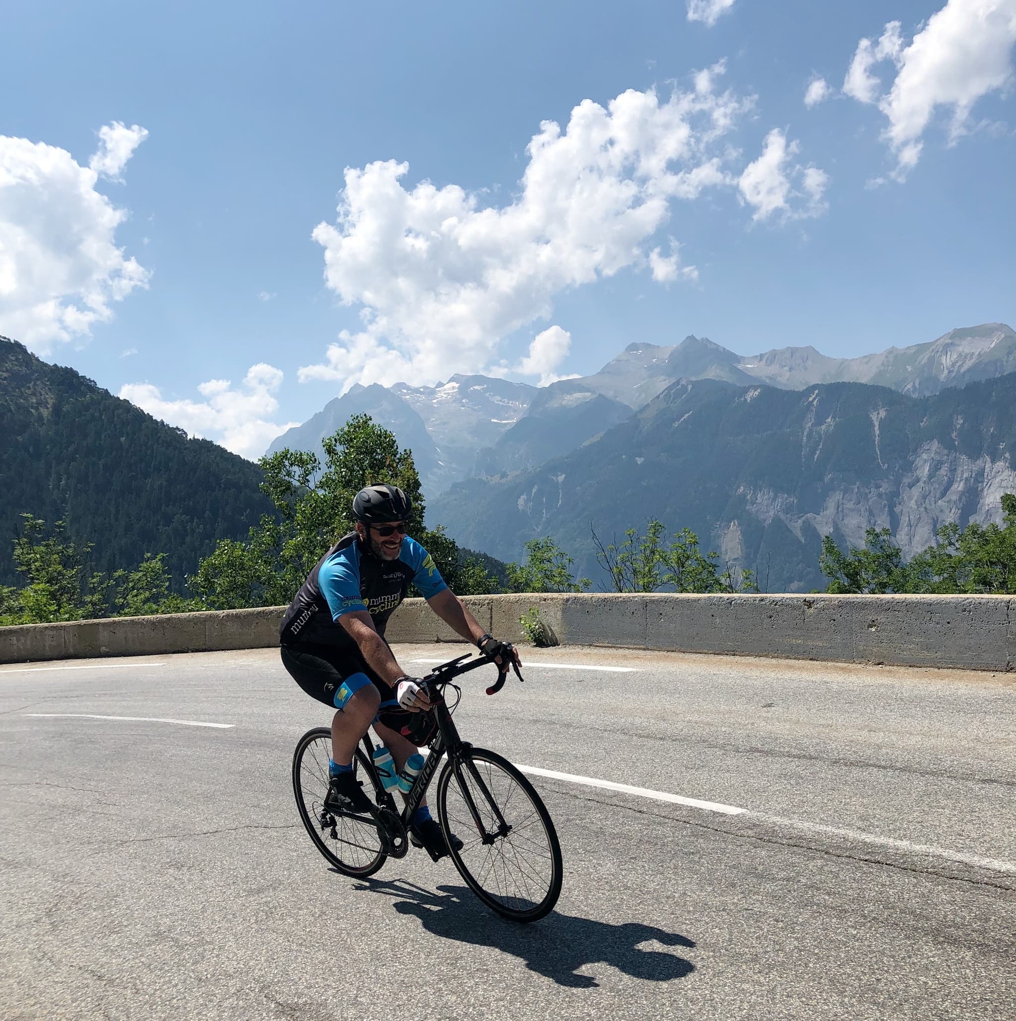 Cyclist on mountain road, scenic landscape