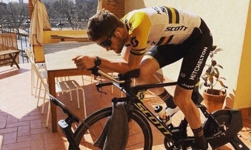 Cyclist on indoor trainer, Jayco AlUla kit