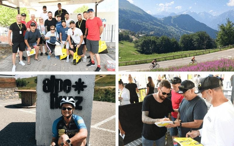 Group photo, cyclists on mountain road, Alpe d'Huez sign, autographs.