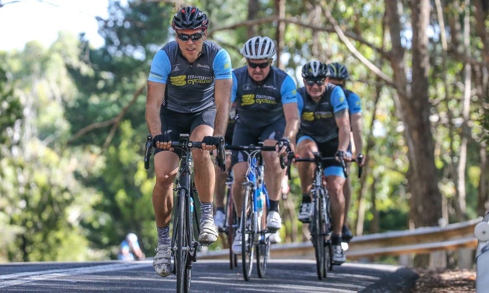 Cyclists in Mummu Cycling kit on a road ride.