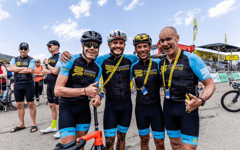 Group of cyclists in Mummu Cycling kit posing for a photo.