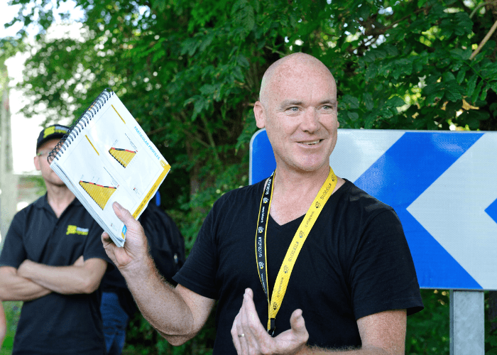 Man holding notebook with climb profiles