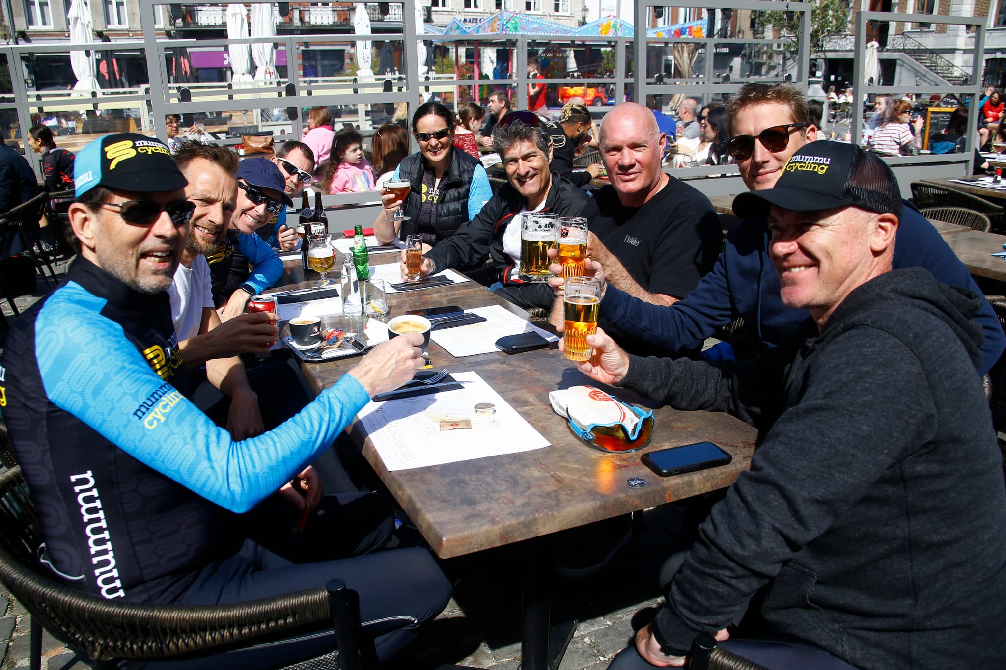 Mummu Cycling group enjoying drinks at an outdoor cafe.